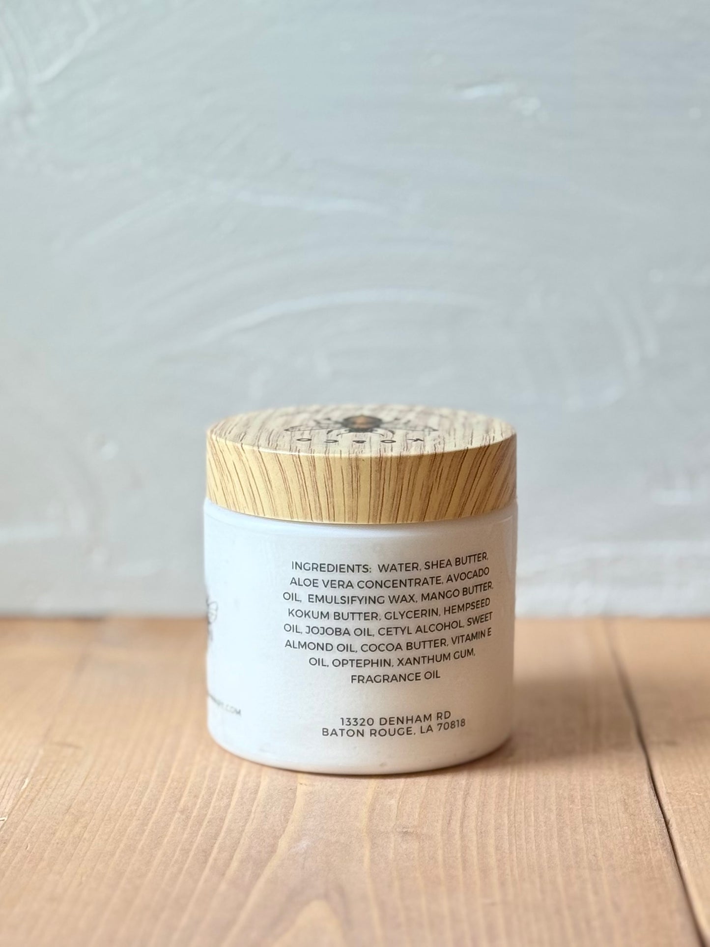 Ingredient label on a Jar of Beach Bum whipped body butter on wood background