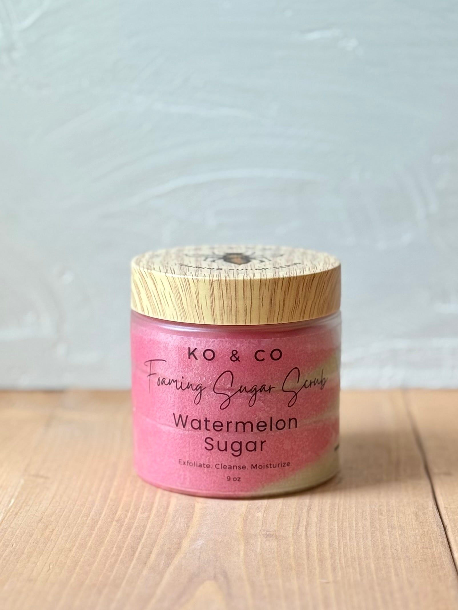 Jar of whipped foaming sugar scrub with a smooth, creamy texture