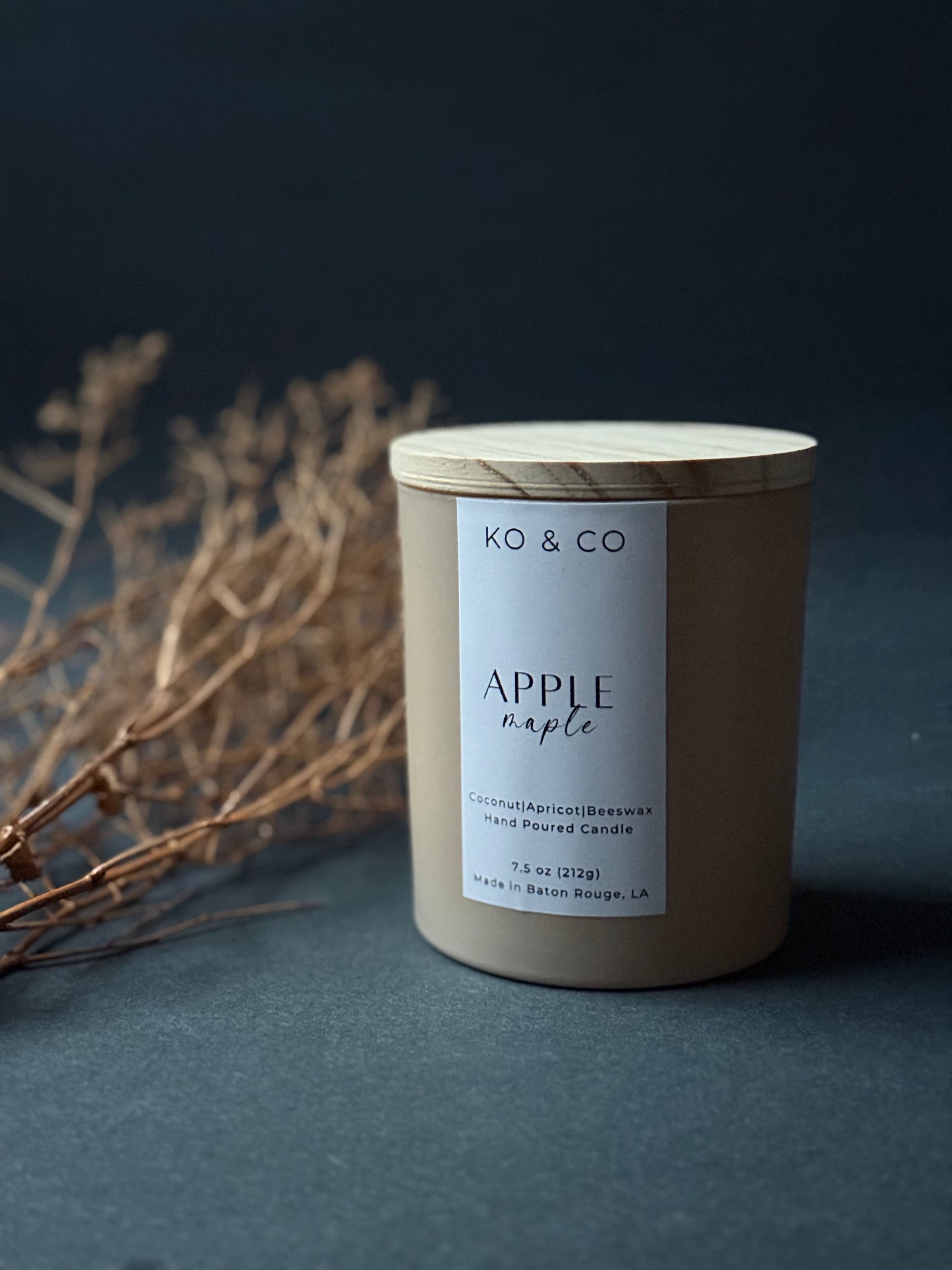 KO & CO candle with wooden lid on a dark background