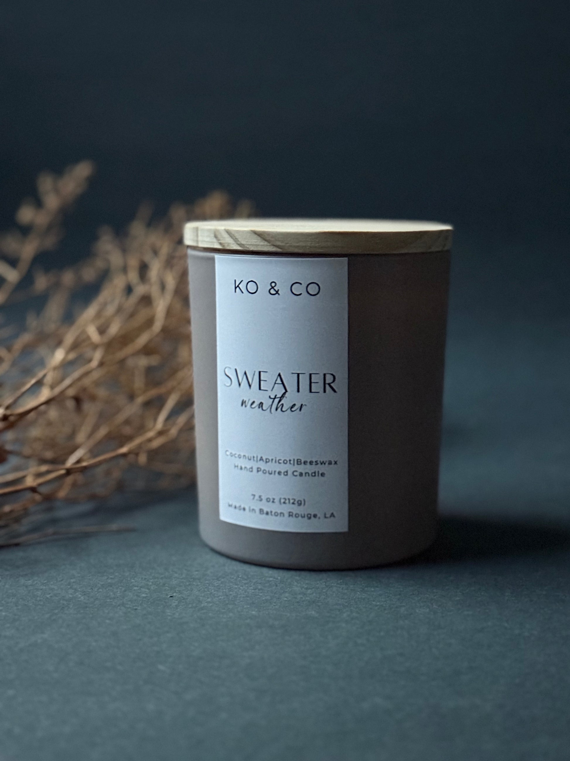 KO & CO candle labeled 'Sweater Weather' on a dark background